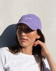 Woman wearing purple Bluejay e-bikes baseball cap