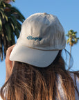 Woman wearing backwards Bluejay e-bikes baseball cap