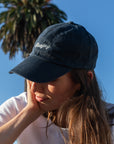 Woman wearing Bluejay e-bikes baseball cap