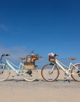 Bluejay Premiere Lite e-bikes in Mint Green and Sunkissed Ivory at beach.