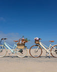 Bluejay Premiere Lite e-bikes in Mint Green and Sunkissed Ivory at beach.