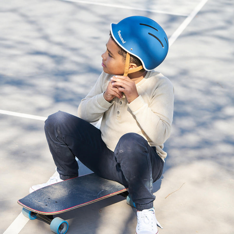 Kid wearing Thousand Jr. Helmet in blue
