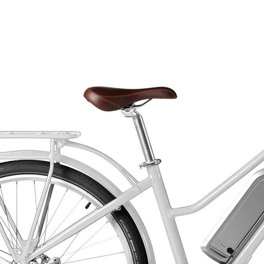 Close-up view of white Bluejay e-bike with brown saddle 