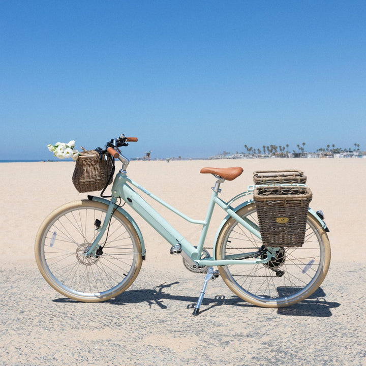 Bluejay Premiere Lite e-bike in Mint Green with Pannier Nantucket baskets at the beach. 