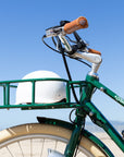 Front view of Bluejay Premiere Edition e-bike in British Racing Green with white helmet