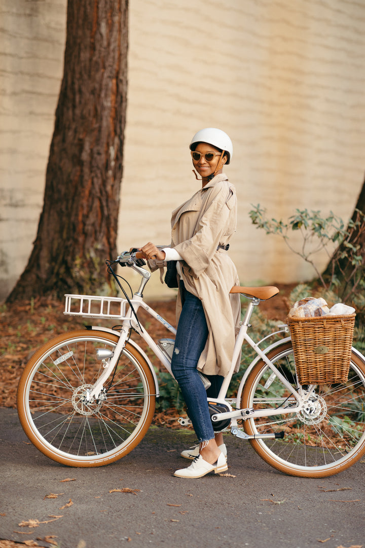 Woman standing with Bluejay Premiere Edition e-bike 