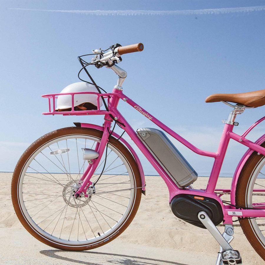 Bluejay Premiere Edition e-bike in Hot Pink with white helmet 