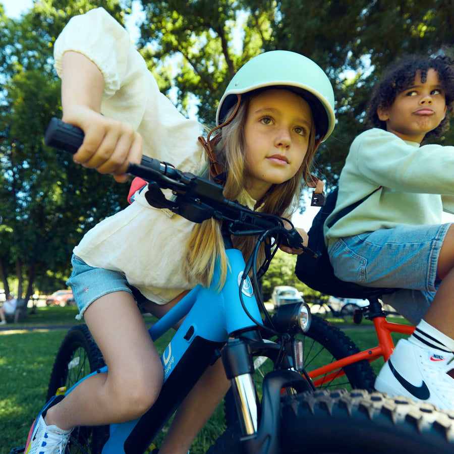 Close-up of children riding Bluejay WILD electric bikes e-bikes