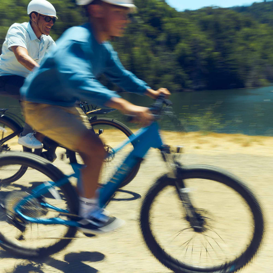 Child and father riding Bluejay electric bikes kids' e-bikes