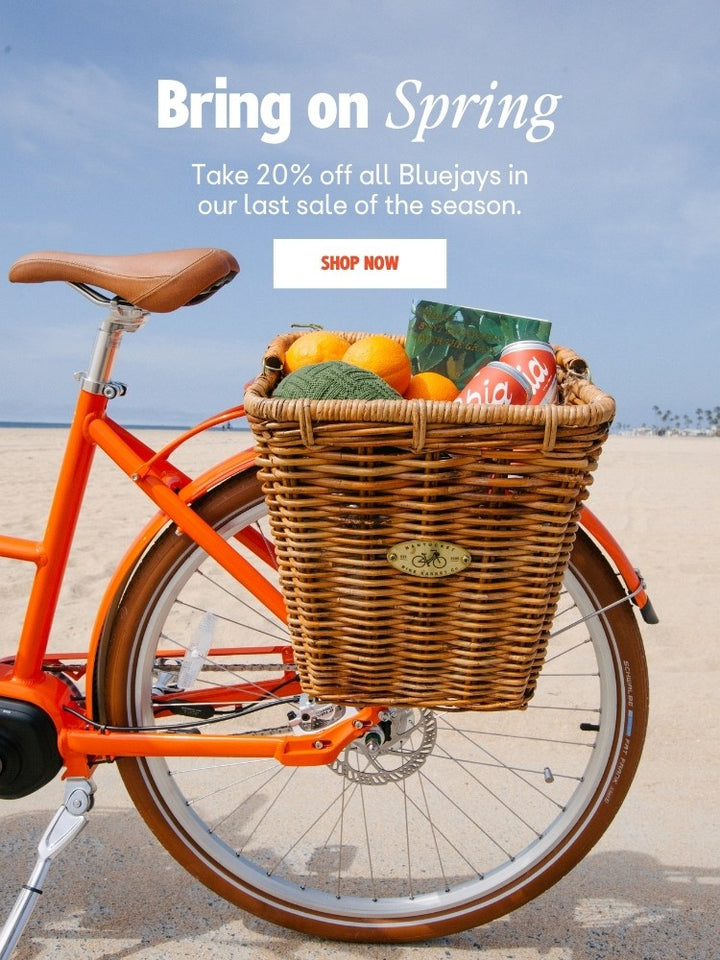 Bluejay Premiere Edition e-bike in Citrus Orange promoting 20% off Spring promo sale. 