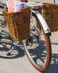 Rear view of Bluejay Premiere Lite e-bike in Modern White with Pannier Nantucket baskets