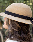 Woman wearing straw hat bike helmet