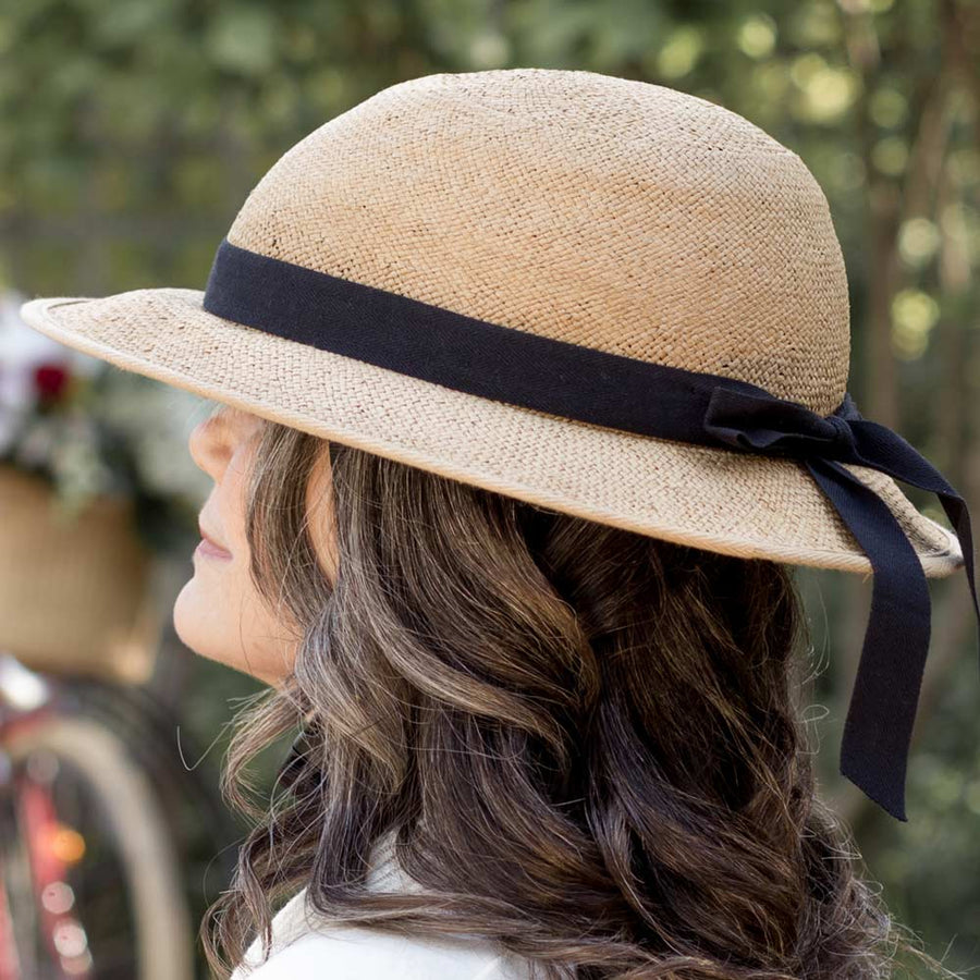 Woman wearing straw hat bike helmet