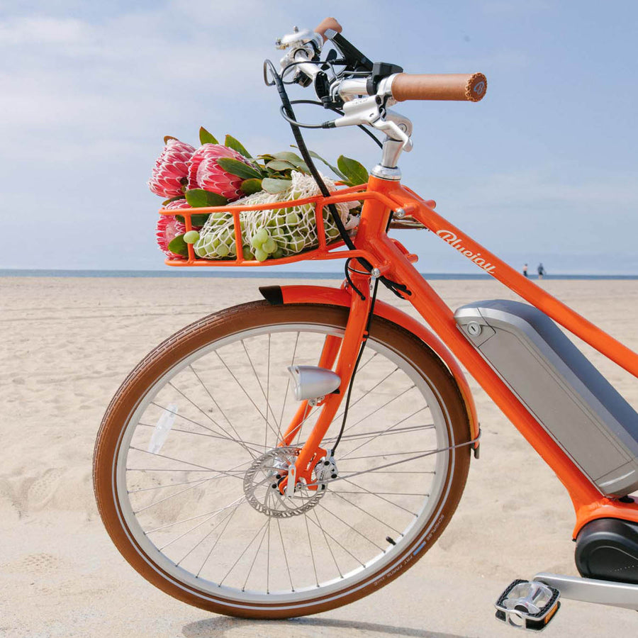 front of citrus orange electric bike by Bluejay